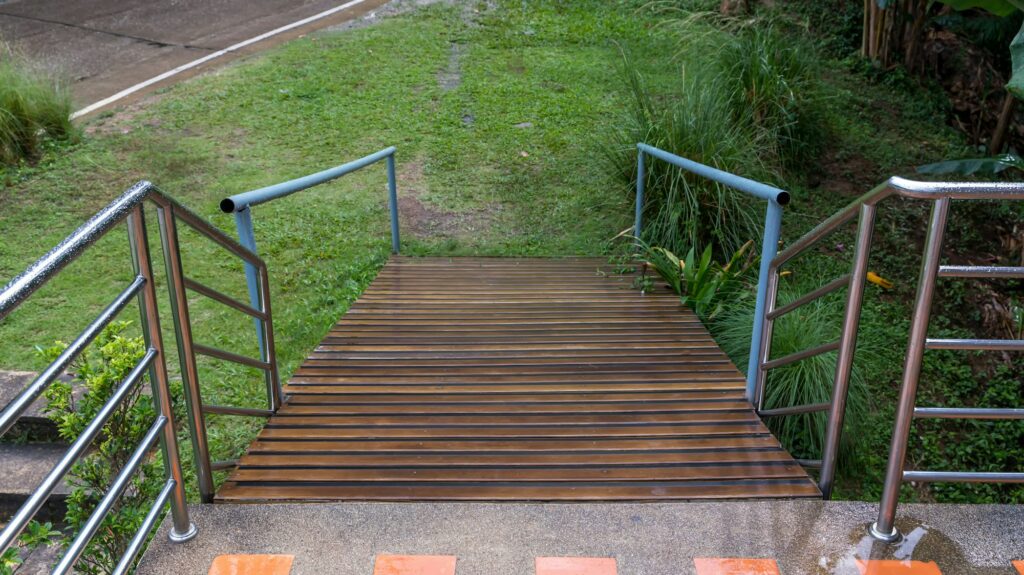 Handicapped traffic symbol on the floor in front of ramp way for support wheelchair.